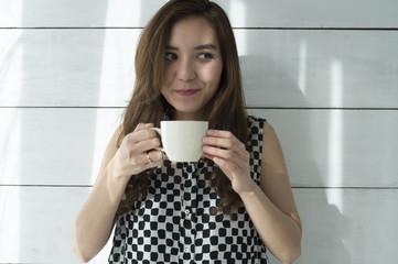 Young women are drinking hot coffee