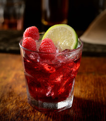 Juice of fresh raspberries served with ice in a glass