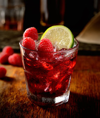 Juice of fresh raspberries served with ice in a glass