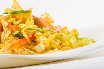 close-up vegetable salad with fish in white plate
