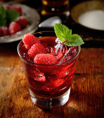 raspberries with sugar on wooden background