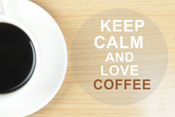 Keep Calm and Love coffee on on wood table background