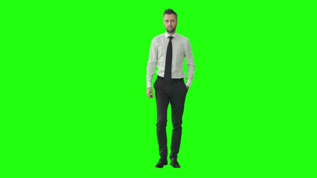 Confident businessman walking towards the camera on green screen background. Suitable for business, marketing, presentations, corporate videos, promotional content