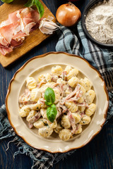 Potato gnocchi, Italian potato dumplings with cheese sauce, ham