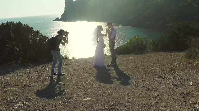 photographer takes a photo of bride and groom