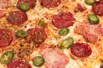 Hot pizza with jalapeno pepper close up