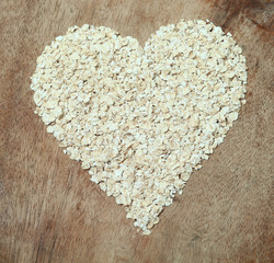 Heart healthy food oats arranged in a heart shape.