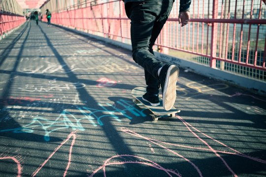 Skateboarder cruise on bridge