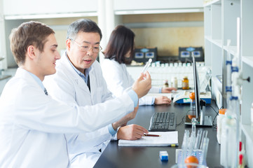 people doing chemical experiment in modern lab