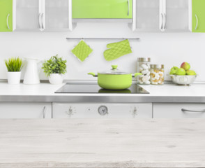 Fototapeta na wymiar Wooden table on green modern kitchen bench interior background