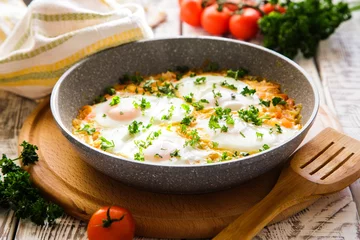 Cercles muraux Oeufs sur le plat Shakshuka - traditional dish of israeli cuisine in a skillet