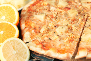 Exotic pizza with tropical fruit and chicken close up