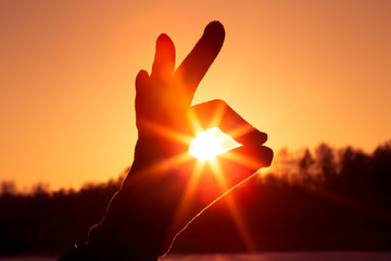 Obraz premium Ok hand sign silhouette at sunset