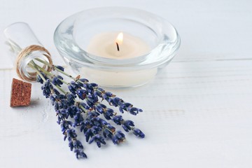 Herbal aromatherapy.  Aroma candle, dried lavender flowers on wooden table. Home refreshing, beauty...