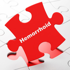 Medicine concept: Hemorrhoid on puzzle background