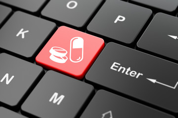 Medicine concept: Pills on computer keyboard background