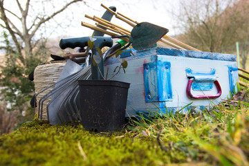 Fototapeta premium Gardening Tools with Garden Flower Pots and Green Plants