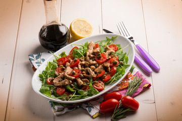 chicken salad with arugula ,tomatoes and balsamic vinegar