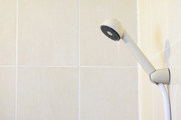 plastic shower head (Selected focus) with little water flows