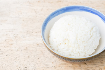Cooked jasmine rice on wooden background