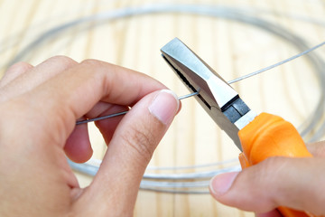 wire,is cut by wire cutter head with orange color handle 