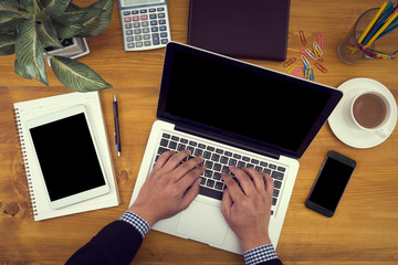 Close up of business man hand working on blank screen laptop com