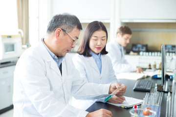 Fototapeta premium people doing chemical experiment in modern lab