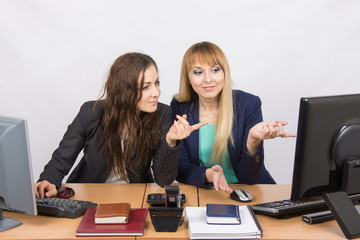 Two colleagues in the office to discuss the electronic document in a computer screen