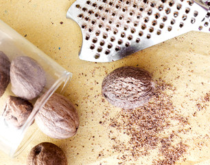 nutmeg with grater over paper