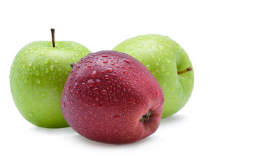 Red and green apple with drops of water on a white background.
