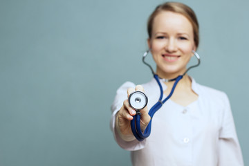 Concept: focus on the stethoscope. Doctor holding a stethoscope.