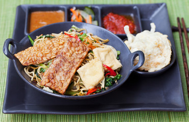 Mi goreng,mee goreng Indonesian cuisine, spicy stir fried noodles with and assortment of asian sauces