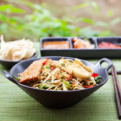 Mi goreng,mee goreng Indonesian cuisine, spicy stir fried noodles with and assortment of asian sauces