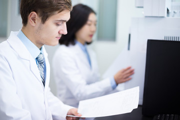 Fototapeta premium people analysis experimental data in computer in lab