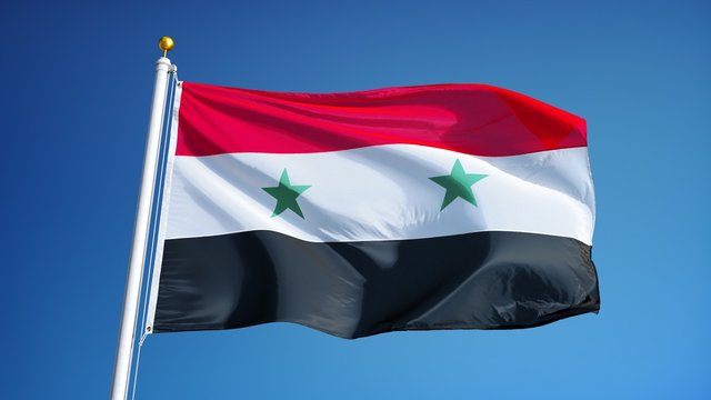 Syria flag waving in slow motion against clean blue sky, seamlessly looped, close up, isolated on alpha channel with black and white luminance matte, perfect for film, news, digital composition