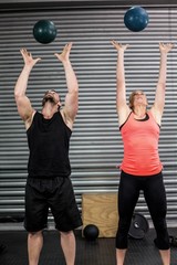 Couple throwing ball in the air