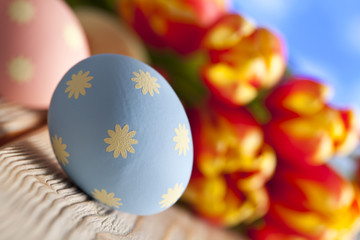 Easter eggs and flowers in background