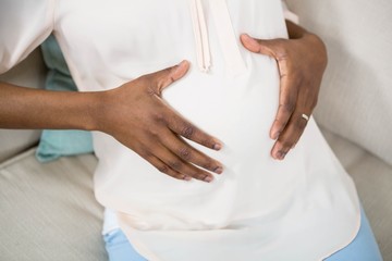 Fototapeta na wymiar Pregnant woman touching her belly