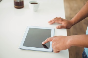 Close up of mans hands using tablet