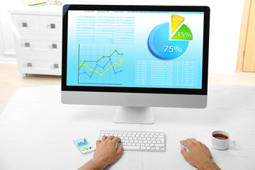 Man working with modern computer, with scheme on screen