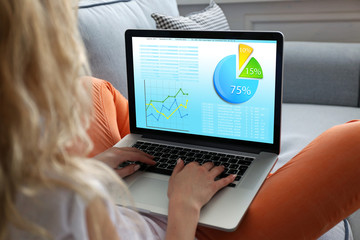 Woman working with modern laptop, with scheme on screen