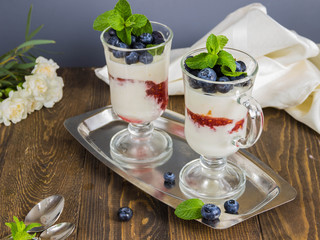 mousse of yoghurt with blueberries and raspberries, and decorated with blueberries and mint