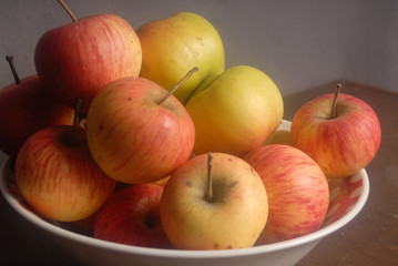 Red apples on the dish.