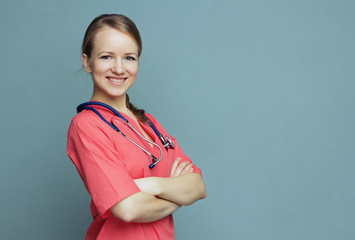 Medical doctor woman   on a blue background smiling.