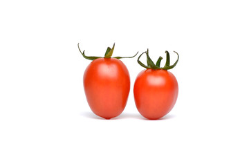 Fresh ripe cherry tomatoes scattered isolated on a white background.