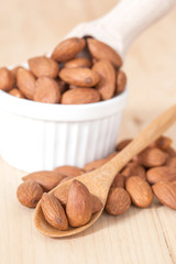 Almonds on wood spoon