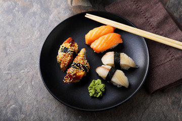  fresh sushi on black plate