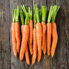 Fresh carrots on wooden table