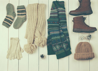 Set of beautiful winter female clothes on wooden background