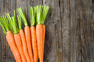Fresh carrots on wooden table